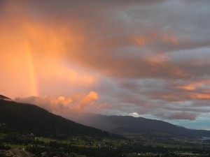 Storm, rainbow, clouds, sun, big sky, drops of rain and wing.  All dancing together.  So powerful!